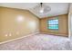 Spacious bedroom with neutral carpet and a large window, creating a calming atmosphere at 13245 Shore Dr, Winter Garden, FL 34787