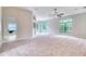 Spacious open living area with large windows, ceiling fan, and view into adjacent dining area with a window seat at 13245 Shore Dr, Winter Garden, FL 34787