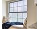Cozy window seat with decorative pillows and a soft blanket for a perfect relaxation spot at 13245 Shore Dr, Winter Garden, FL 34787