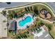 Aerial view of the community pool and playground featuring a unique shape and well-maintained landscaping at 14001 Jomatt Loop, Winter Garden, FL 34787