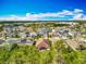 Aerial view showcases modern homes, lush landscaping, and solar panels surrounded by trees in a serene residential community at 14001 Jomatt Loop, Winter Garden, FL 34787