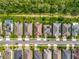 Aerial view showcases homes with solar panels and pools, alongside manicured lawns and tree-lined streets in residential neighborhood at 14001 Jomatt Loop, Winter Garden, FL 34787