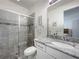 Elegant bathroom features a spacious shower, granite countertop, and modern fixtures at 14001 Jomatt Loop, Winter Garden, FL 34787