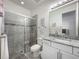 Modern bathroom with glass-enclosed shower, granite countertop, and ample lighting at 14001 Jomatt Loop, Winter Garden, FL 34787