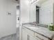 Stylish bathroom featuring granite countertop, white cabinets, and modern fixtures at 14001 Jomatt Loop, Winter Garden, FL 34787