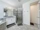 Bathroom featuring double sink vanity, granite countertop, walk-in shower, and tile flooring at 14001 Jomatt Loop, Winter Garden, FL 34787