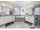 Bathroom featuring double sink vanity with granite counters, soaking tub, and glass shower enclosure at 14001 Jomatt Loop, Winter Garden, FL 34787