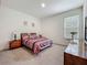 Comfortable bedroom with soft carpet, natural light from the window, and simple decor at 14001 Jomatt Loop, Winter Garden, FL 34787
