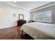 Bright bedroom with hardwood floors, a large window, and a built-in desk area at 14001 Jomatt Loop, Winter Garden, FL 34787