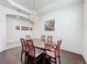 Bright dining room features a large dark wood table and wood floors at 14001 Jomatt Loop, Winter Garden, FL 34787