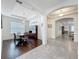 Elegant dining room with tray ceiling, dark wood flooring, and transitional views into other rooms at 14001 Jomatt Loop, Winter Garden, FL 34787