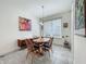Charming dining room with natural light, a round wooden table, and elegant decor at 14001 Jomatt Loop, Winter Garden, FL 34787