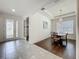 Bright dining room with chandelier, wood floors, and a view of the entry way at 14001 Jomatt Loop, Winter Garden, FL 34787