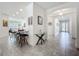 View of the entryway leading to the kitchen and dining room with tile floors at 14001 Jomatt Loop, Winter Garden, FL 34787