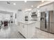 Bright kitchen features stainless steel appliances, an island with granite countertops, and ample cabinet space at 14001 Jomatt Loop, Winter Garden, FL 34787