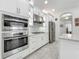 Modern kitchen with built in oven, cooktop and stainless steel appliances at 14001 Jomatt Loop, Winter Garden, FL 34787