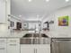 Modern kitchen features stainless steel appliances, granite countertops, and an open view to the living room at 14001 Jomatt Loop, Winter Garden, FL 34787