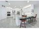 Bright, white kitchen featuring an island with seating and stainless steel appliances at 14001 Jomatt Loop, Winter Garden, FL 34787