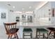 The kitchen features a large island with seating, white cabinets, and modern appliances at 14001 Jomatt Loop, Winter Garden, FL 34787