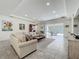 Spacious living room with neutral tones, large sectional sofa, and seamless access to the screened lanai at 14001 Jomatt Loop, Winter Garden, FL 34787
