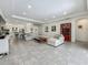 Spacious living room with tile flooring, a sectional sofa, and an open layout perfect for entertaining at 14001 Jomatt Loop, Winter Garden, FL 34787