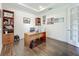 Comfortable home office featuring dark hardwood floors, built-in bookshelves, and natural light at 14001 Jomatt Loop, Winter Garden, FL 34787