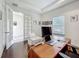 Functional home office featuring hardwood floors, a spacious desk setup, and large windows for ample lighting at 14001 Jomatt Loop, Winter Garden, FL 34787