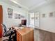 Bright and airy home office with hardwood floors, a desk, and ample natural light from a double door at 14001 Jomatt Loop, Winter Garden, FL 34787