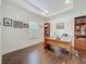 Bright home office with hardwood floors, tray ceiling, desk, and built-in shelving at 14001 Jomatt Loop, Winter Garden, FL 34787
