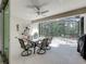 Covered patio with ceiling fan, dining table, and screened enclosure overlooking the backyard at 14001 Jomatt Loop, Winter Garden, FL 34787