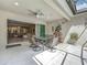 Covered patio with ceiling fan, dining table, and views into the home's interior at 14001 Jomatt Loop, Winter Garden, FL 34787