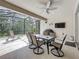 Screened patio with a ceiling fan, dining table, grill, and TV for entertaining at 14001 Jomatt Loop, Winter Garden, FL 34787