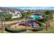 View of the community playground, pool and other outdoor amenities surrounded by lush landscaping at 14001 Jomatt Loop, Winter Garden, FL 34787
