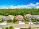 Street view of three homes with manicured lawns, mature landscaping, and parked cars at 14001 Jomatt Loop, Winter Garden, FL 34787