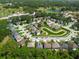 Captivating community view with a winding street featuring homes encircling a peaceful pond and surrounding greenery at 145 Circle Hill Rd, Sanford, FL 32773