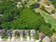 Bird's eye view capturing a neighborhood with verdant foliage, community golf course, and tranquil ponds at 145 Circle Hill Rd, Sanford, FL 32773