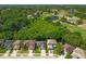 An aerial shot shows homes adjacent to green space with ponds and a golf course in a vibrant community at 145 Circle Hill Rd, Sanford, FL 32773