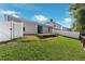 A well-maintained backyard with a small wooden deck and lush lawn, perfect for outdoor enjoyment and relaxation at 145 Circle Hill Rd, Sanford, FL 32773