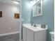 Bathroom featuring light blue walls, a white vanity with a modern sink, and tiled laminate flooring at 145 Circle Hill Rd, Sanford, FL 32773