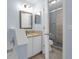Bathroom features a shower, toilet, vanity with granite countertops, a framed mirror, and light blue walls at 145 Circle Hill Rd, Sanford, FL 32773