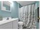 Bathroom with a shower curtain with a floral pattern, light blue walls, and a modern vanity sink at 145 Circle Hill Rd, Sanford, FL 32773