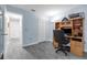 The bright bedroom boasts wood-look floors, a built-in desk area, and a closet, offering both functionality and style at 145 Circle Hill Rd, Sanford, FL 32773