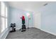 An exercise room featuring light blue walls, gray laminate flooring, and weight lifting equipment at 145 Circle Hill Rd, Sanford, FL 32773