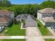 The aerial view showcases a well-maintained home with lush landscaping, a driveway, and a serene setting in a friendly neighborhood at 145 Circle Hill Rd, Sanford, FL 32773
