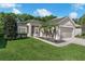 Inviting single-story home with a well-manicured lawn, lush landscaping, and a two-car garage at 145 Circle Hill Rd, Sanford, FL 32773