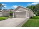 Spacious two-car garage with manicured lawn, and adjacent landscaping at 145 Circle Hill Rd, Sanford, FL 32773