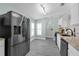 Modern kitchen with stainless steel appliances, granite countertops, and contemporary flooring at 145 Circle Hill Rd, Sanford, FL 32773