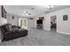 Open living room with gray floors, vaulted ceiling, and french doors to the backyard at 145 Circle Hill Rd, Sanford, FL 32773