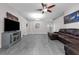Bright living room with gray floors, recessed lighting, and furniture at 145 Circle Hill Rd, Sanford, FL 32773