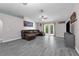 Living room featuring gray floors, vaulted ceiling, and french doors to the backyard at 145 Circle Hill Rd, Sanford, FL 32773